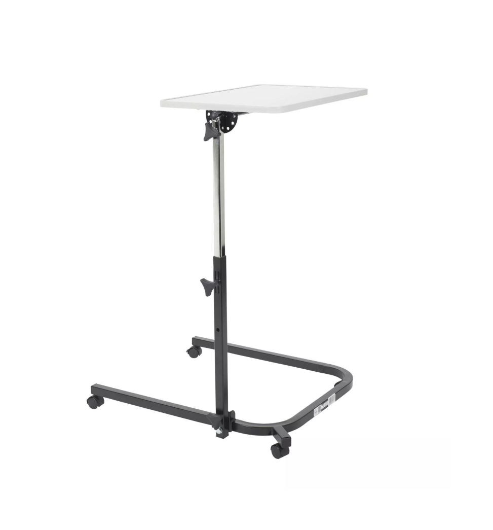 Adjustable height table with white surface on a white background