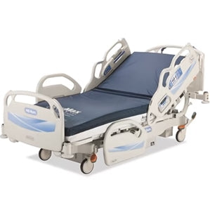 Hospital bed with foam mattress, Hill Rom Advanta 2 model, featuring adjustable side rails and ergonomic design for patient comfort.