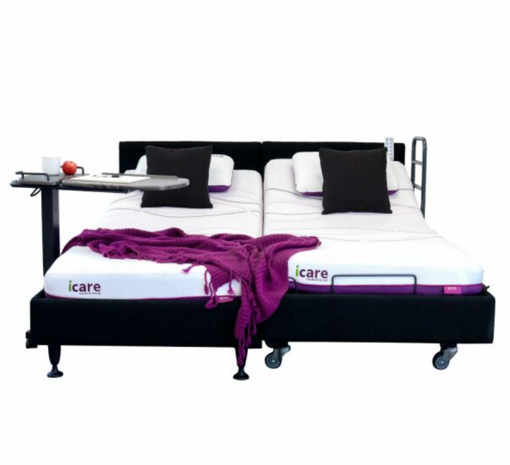 An adjustable electric bed frame with two mattresses, shown on a white background. The bed frame is upholstered in black fabric and has a metal support frame.